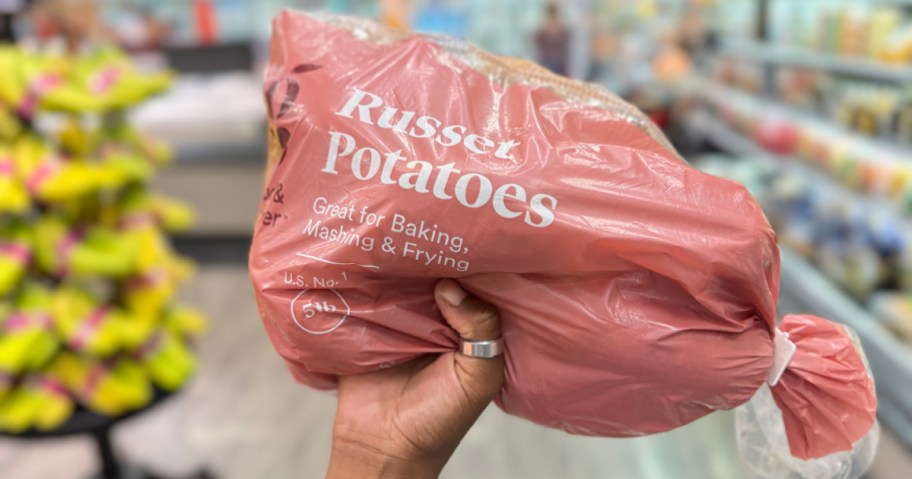 person holding up Good & Gather Russet Potatoes &ndash; 5lb bag in target store