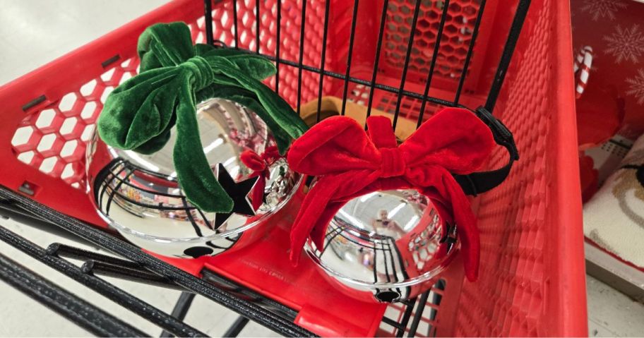 two large Christmas metal bells with ribbon on them 