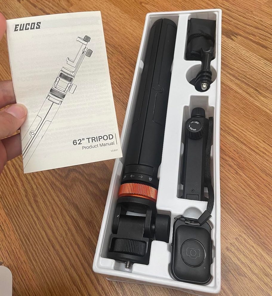 hand holding instruction manual for tripod
