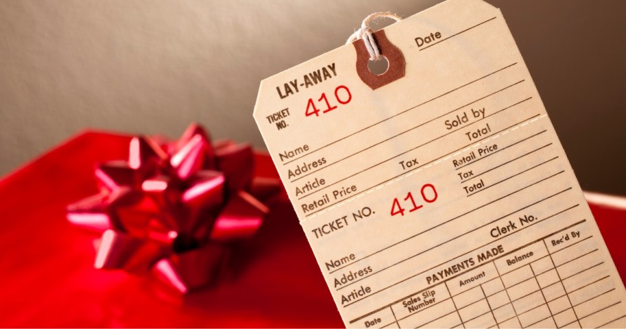 Layaway retail tag with red wrapped present in background