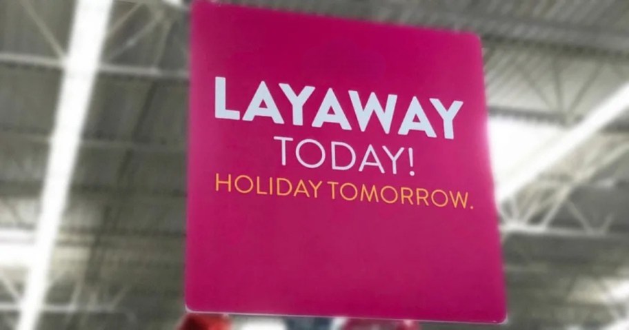 Layaway pink sign hanging below ceiling in store