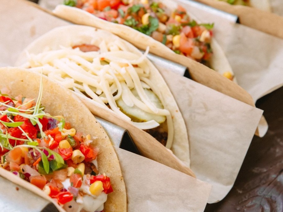 3 tacos on parchment paper