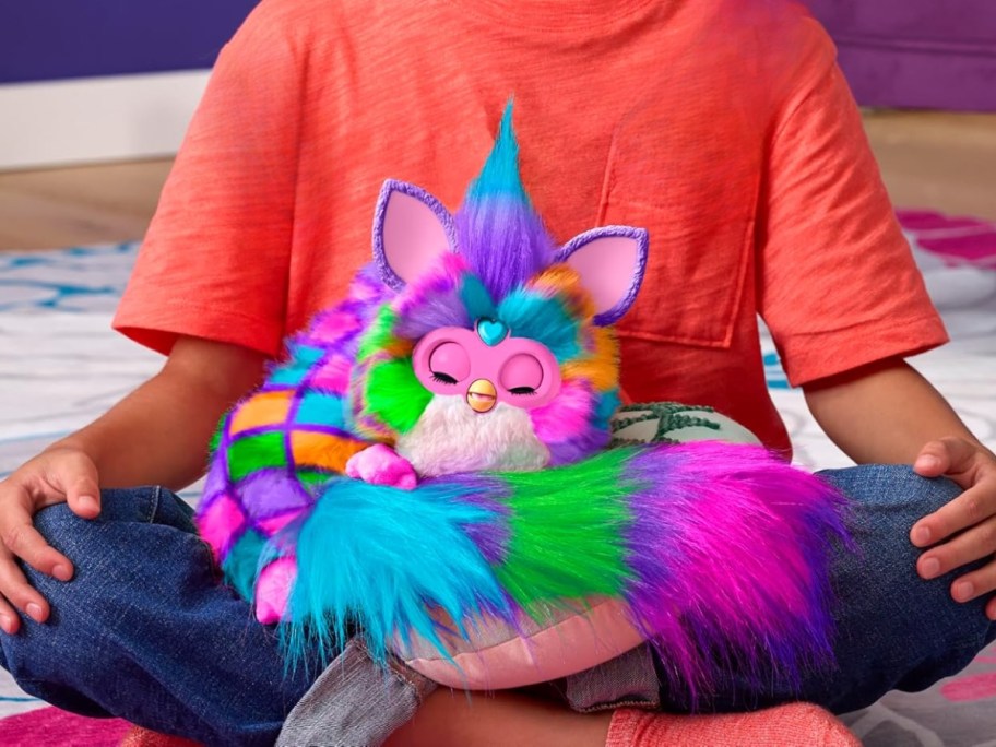kid with a fuzzy animal DJ Furby toy on his lap