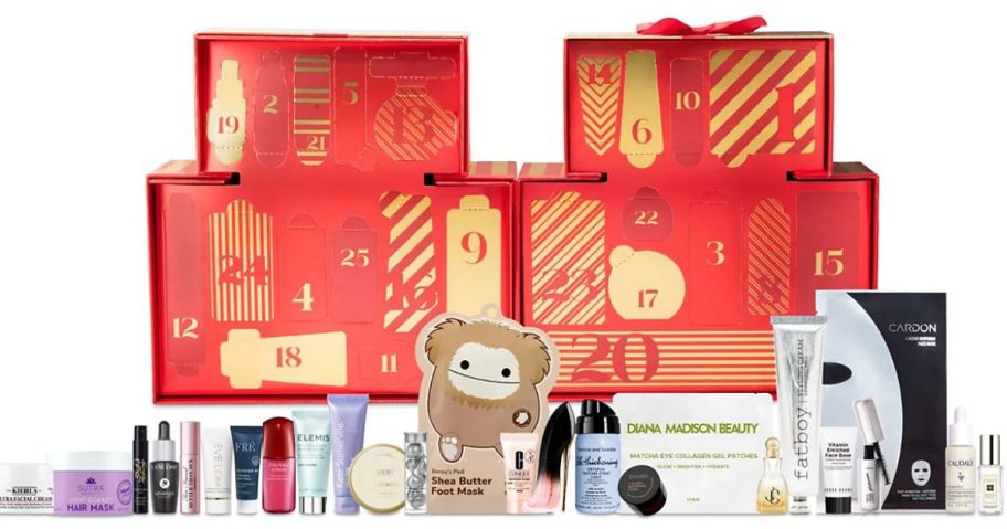 A red and gold gift box with beauty products in front of it 