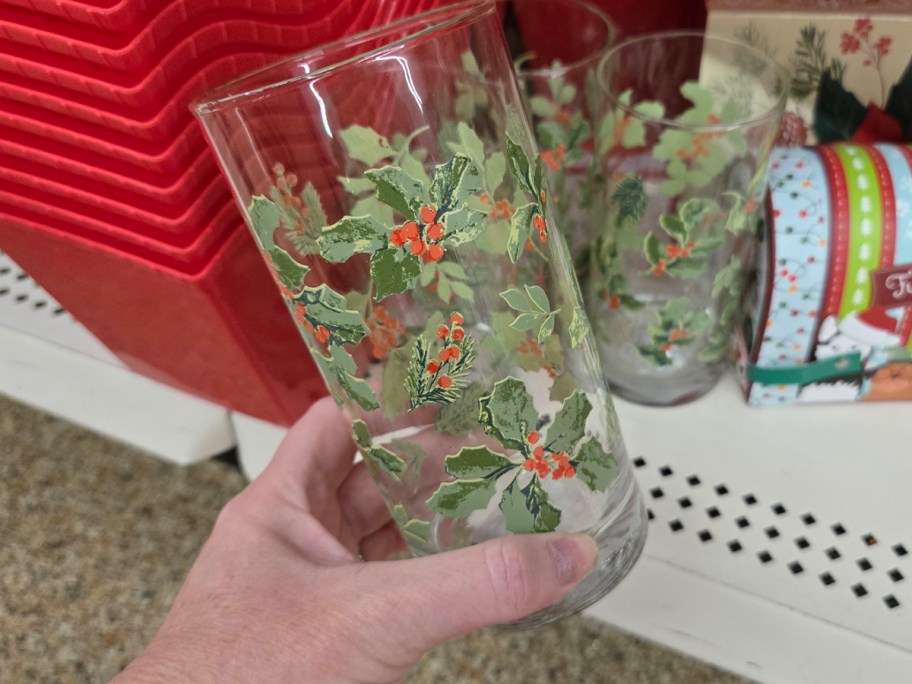 glass cup with red and green plants on it 