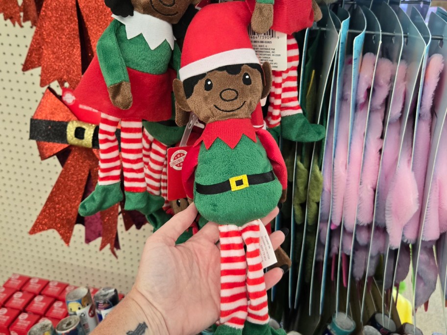 hand holding elf plush toy 