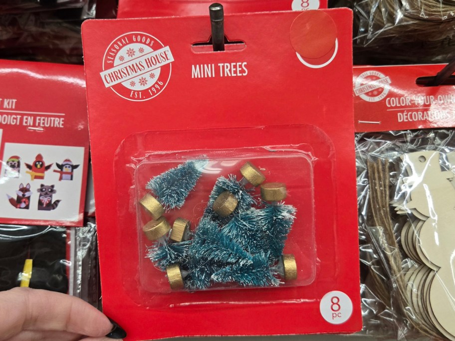 hand holding pack of mini trees 