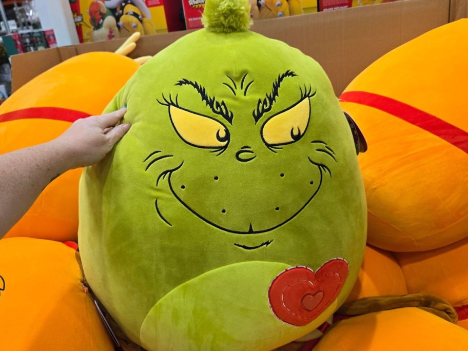 Grinch Squishmallow in hand in store