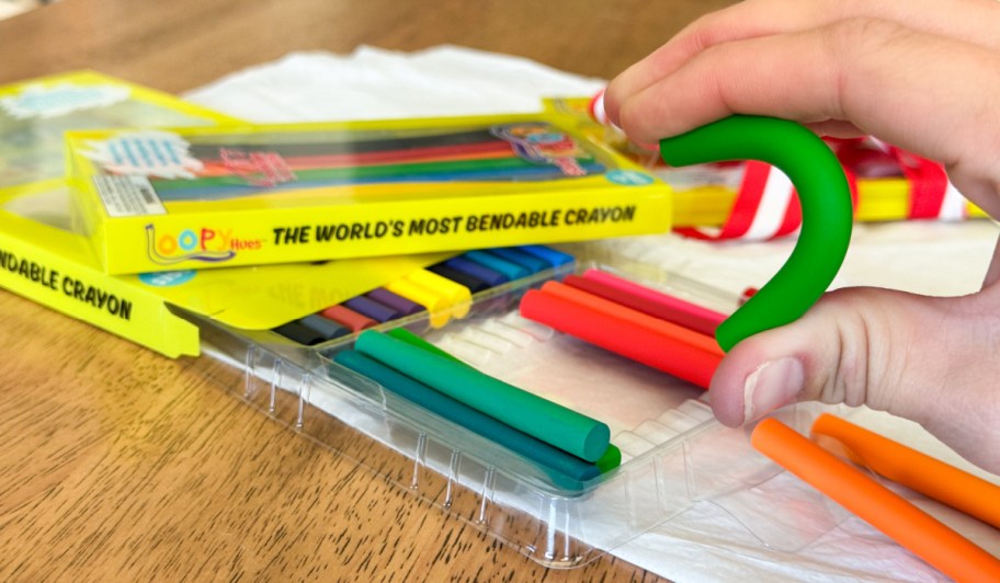 hand holding loopy hues bendable crayons and bending crayon