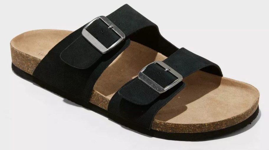 Men&rsquo;s black two-strap slide sandal with silver buckle accents and a cork footbed, shown on a white background.