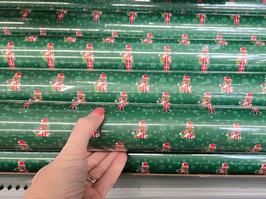hand holding Snoop on The Stoop Green Gift Wrap in store