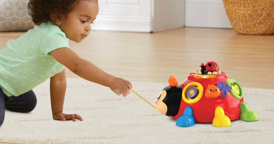 baby pulling vtech lady bug toy