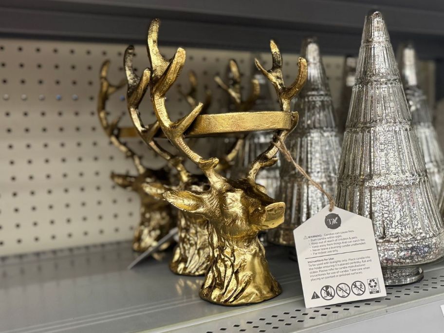 Gold Stag Pillar Holders on shelf in store
