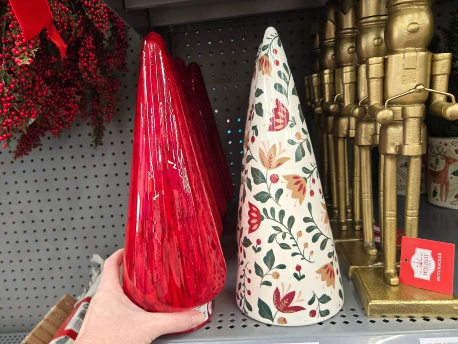 two chrustmas tree decor pieces on shelf in store