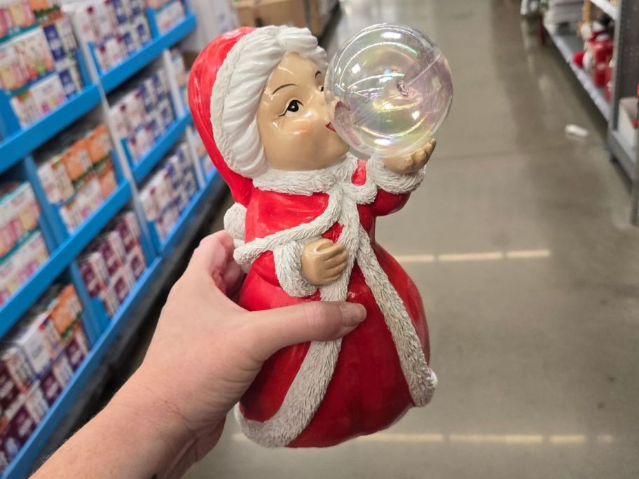 mrs claus with bubble in hand in store