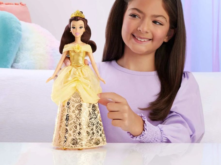 girl holding Disney Princess Enchanted Stories Belle Fashion Doll