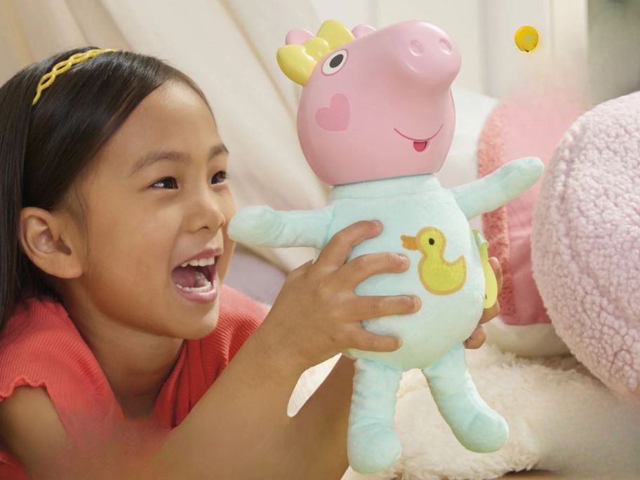 kid playing with Peppa Pig Oinks + Snuggles Baby Evie Interactive Baby Doll