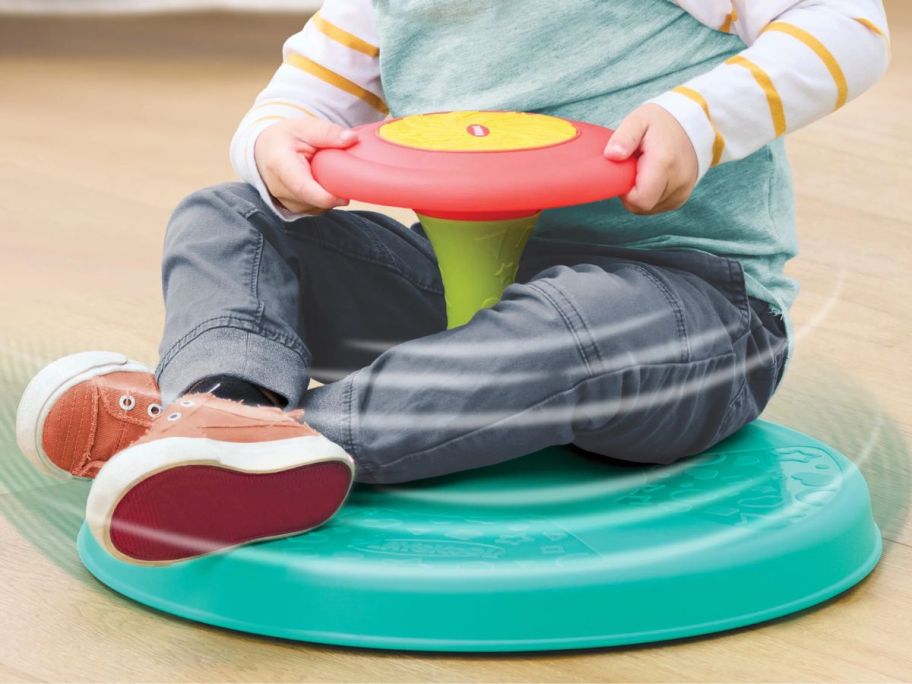 kid sitting on Playskool Sit &rsquo;n Spin Activity Toy