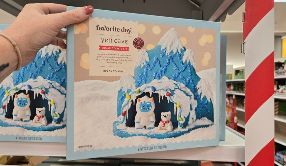 a woman reaching for a yeti cookie kit on a store shelf