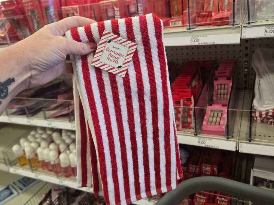 red and white striped hand towel in hand in store