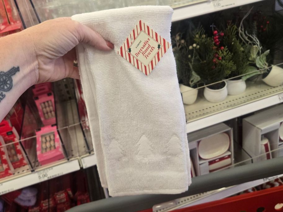 white decorative christmas hand towel in hand in store