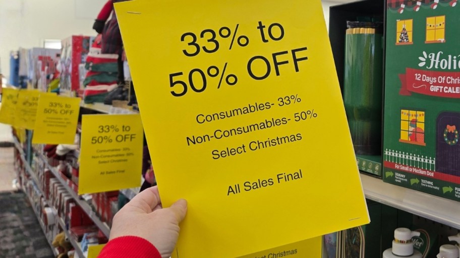 womans hand holding cvs clearance sign