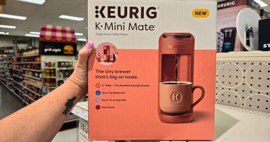 hand reaching for a Keurig K Mini Mate Coffee Machine in a box on a store shelf