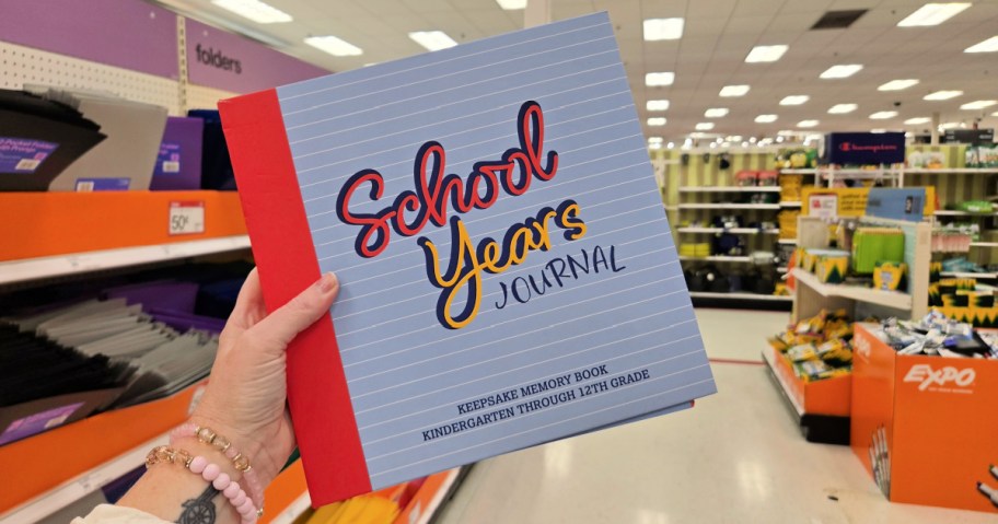 school journal in hand in a store aisle