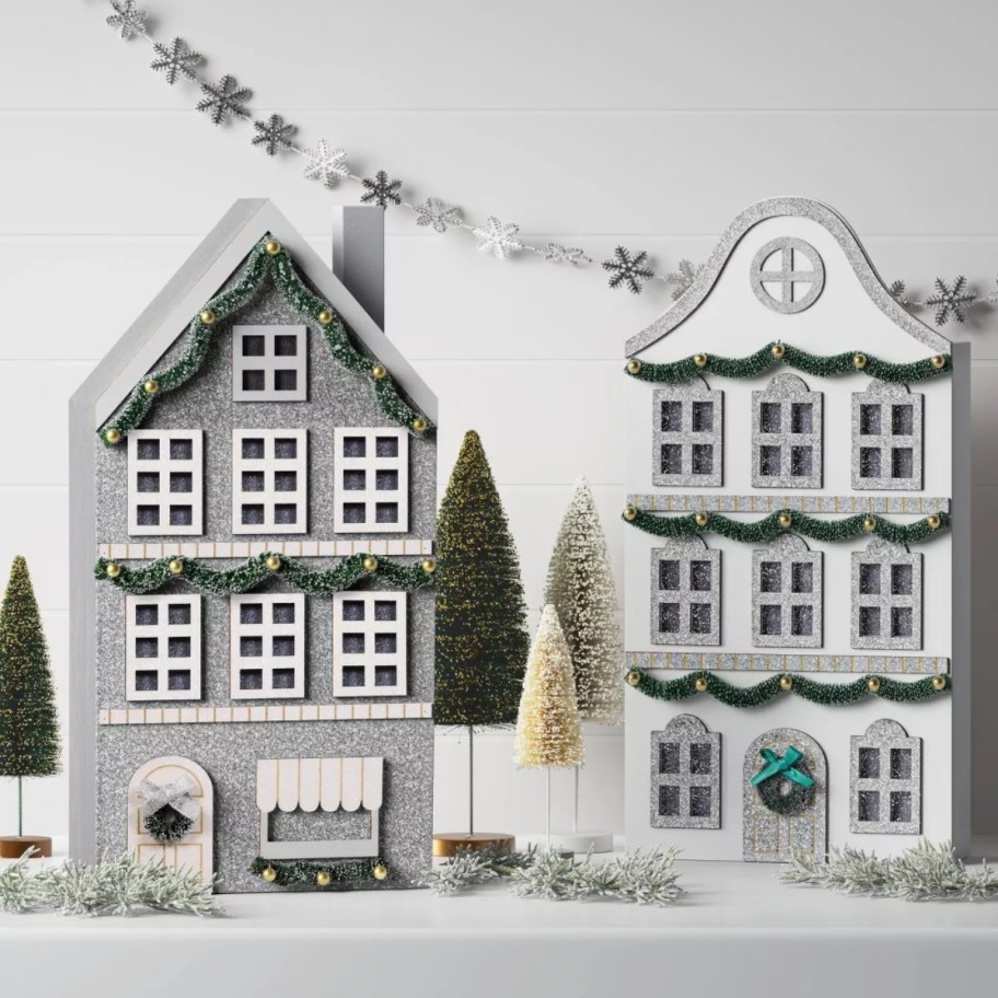 two Christmas decor mantle houses on a mantle