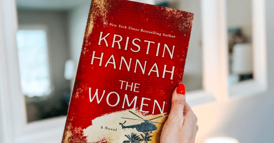 hand holding a book called the women