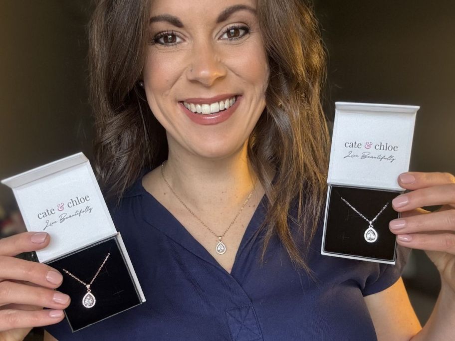 Woman holding two Cate & Chloe Isabel Necklaces in boxes next to one she is wearing on her neck