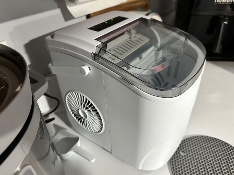 A white ice maker on the counter
