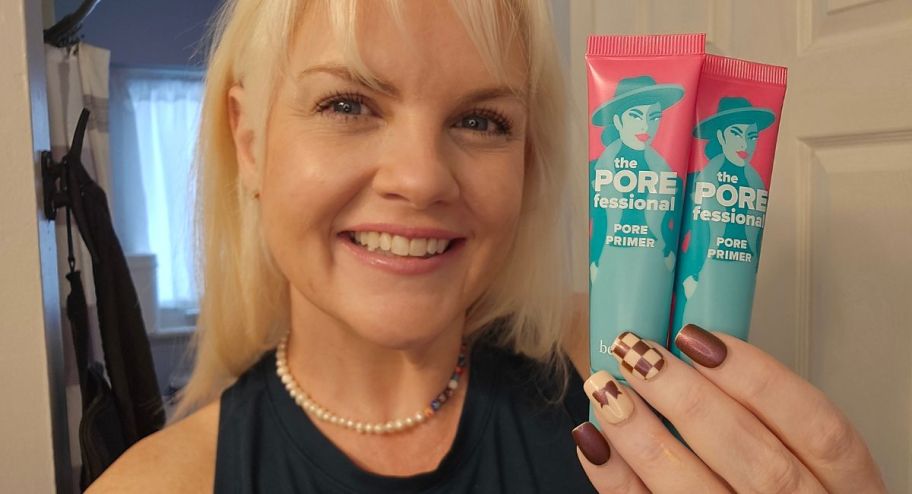 woman holding two tubes of benefit cosmetics primer 