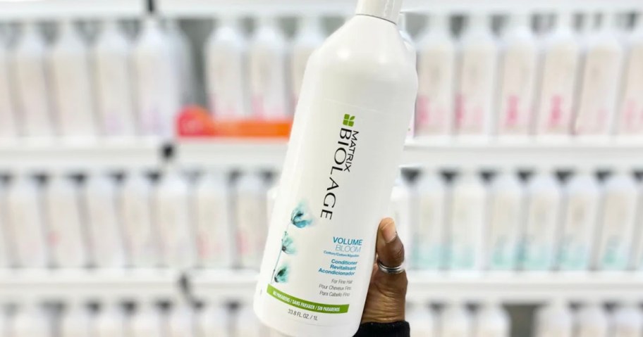 hand holding biolage shampoo bottle