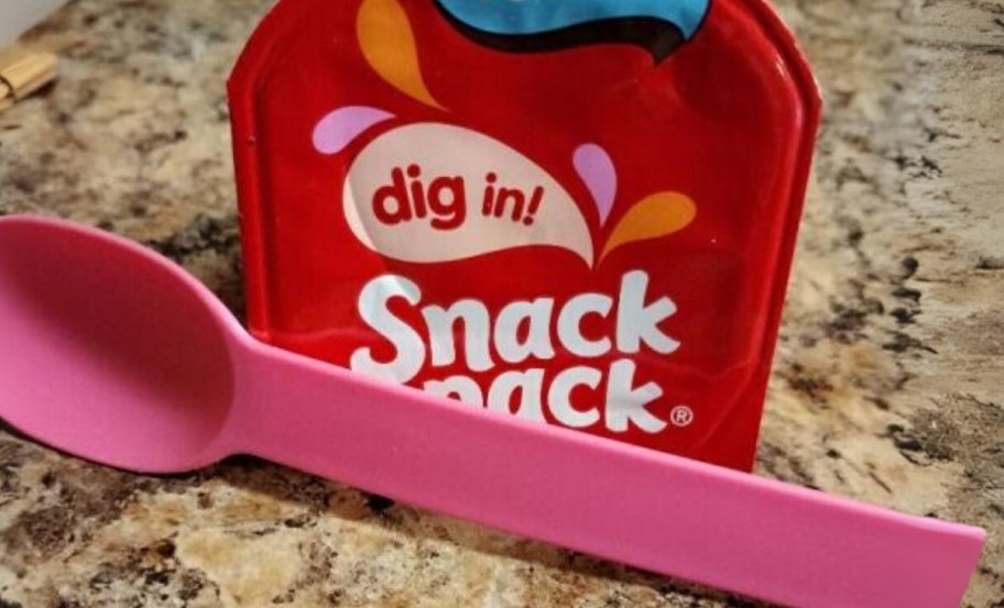 a snack pack gel cup with a pink plastic spoon