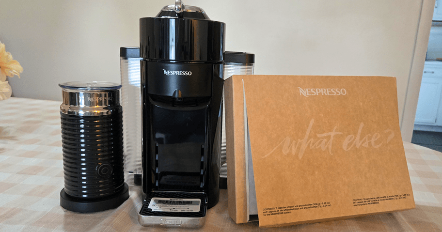 Nespresso Evoluo Coffee & Espresso Maker w/ Frother, 12 Nespresso Capsules on a counter