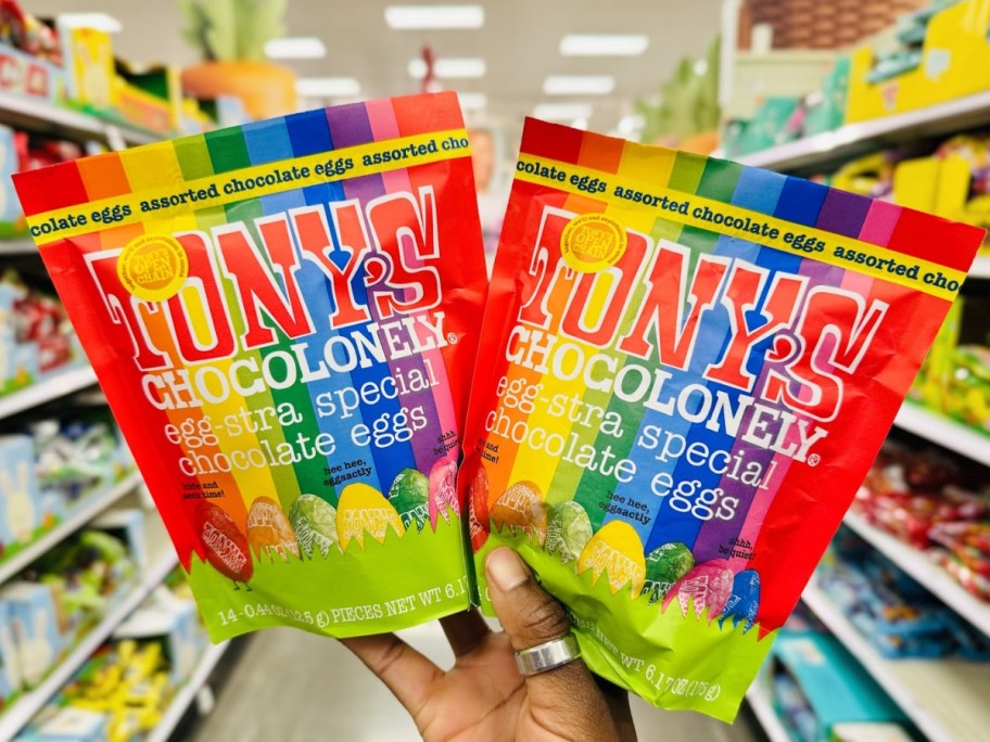 hand holding up 2 Tony's Chocolonely Easter Egg Pouches in store