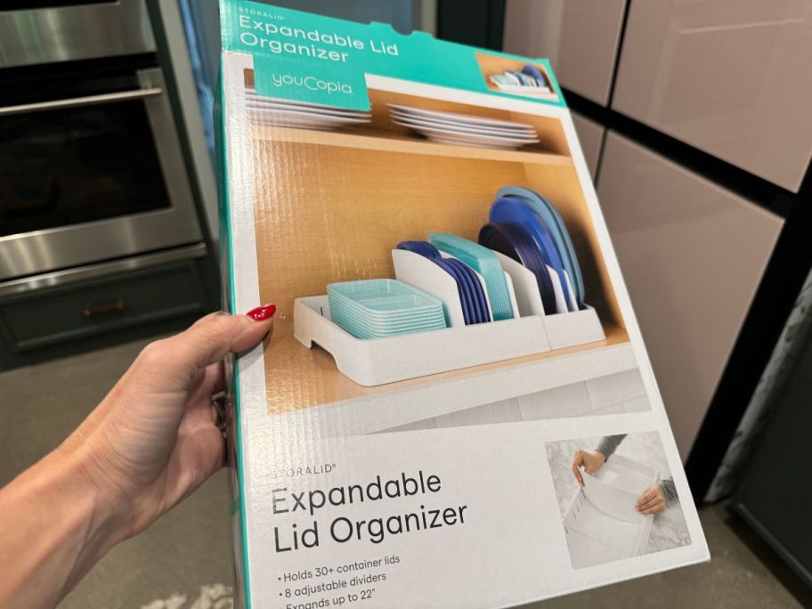 hand holding up YouCopia Expandable Lid Organizer box