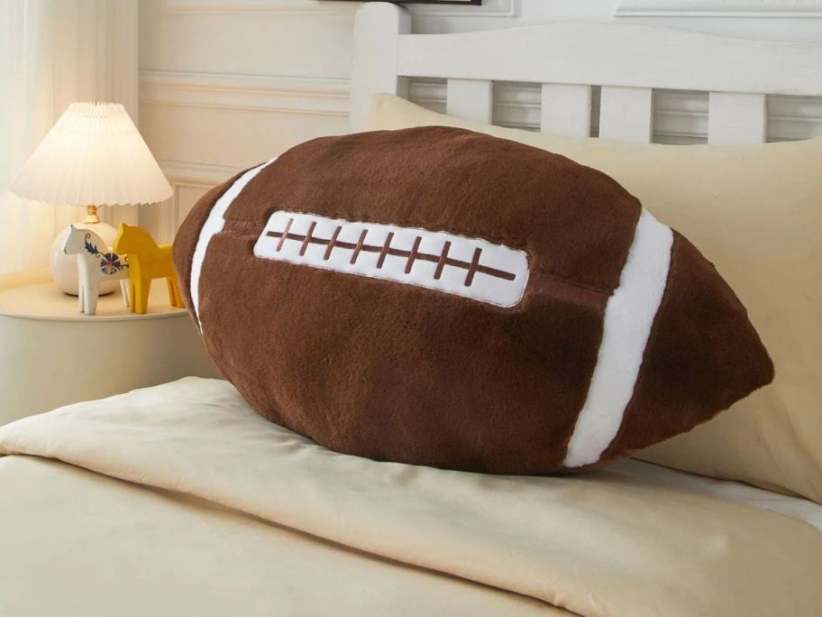 Your Zone Football Shaped Figural Body Pillow on bed