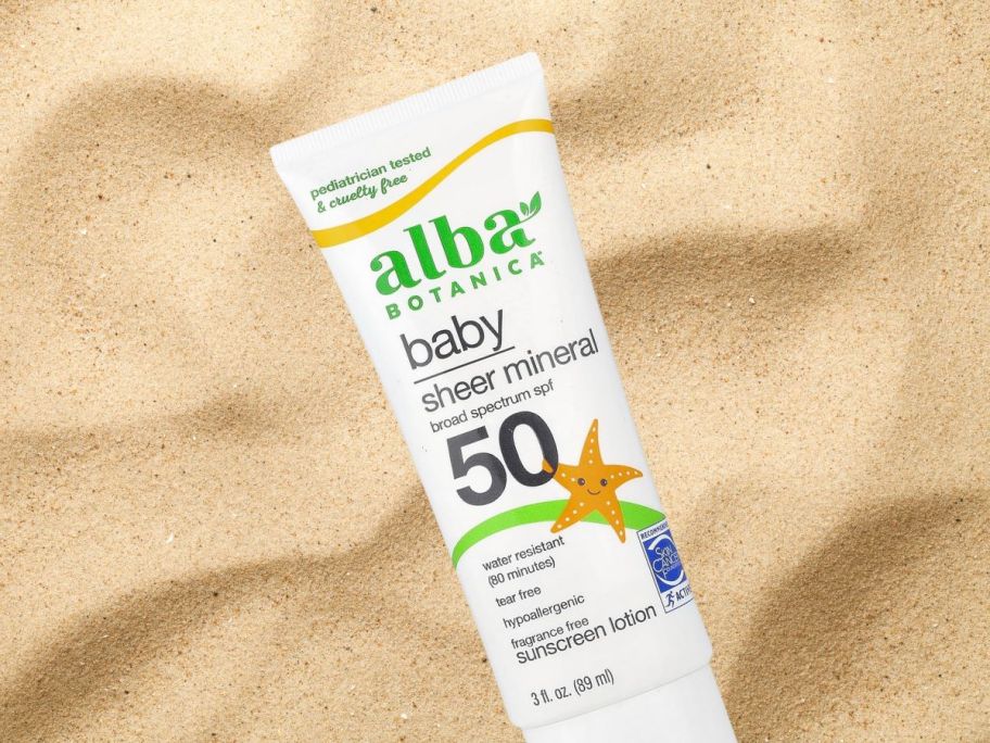 Alba Botanica Baby Sunscreen 3oz bottle on sand