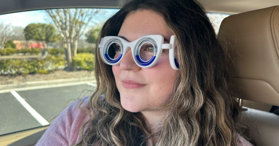 young woman wearing motion sickness glasses in a car