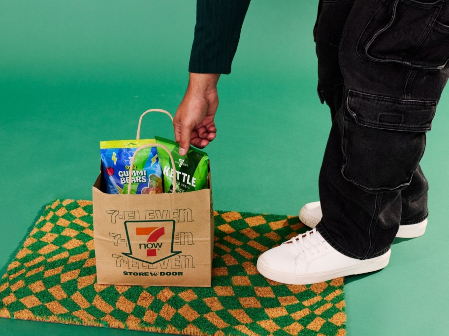 pulling snacks from a 7 Eleven paper bag