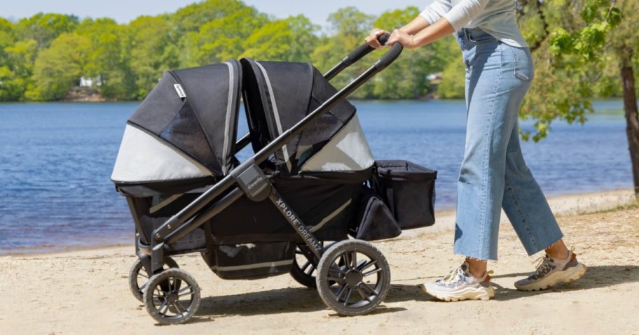 Woman pushing Evenflo stroller wagon outside