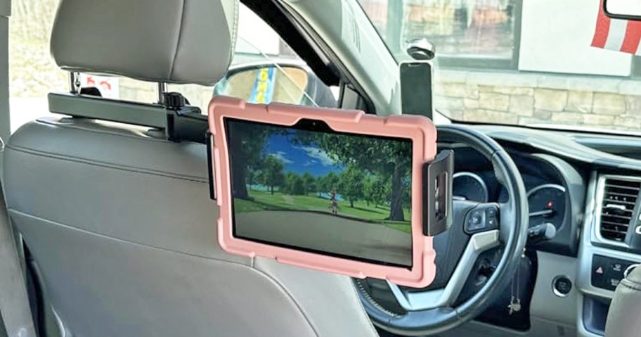 tablet attached to a car seat headrest in car
