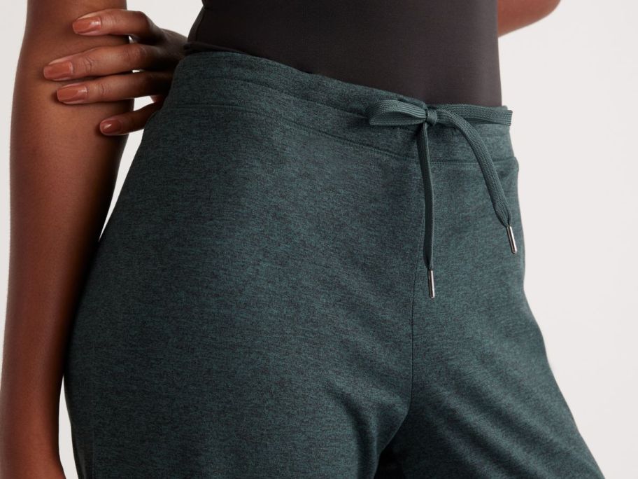 The waistline of a woman wearing quince wide leg joggers