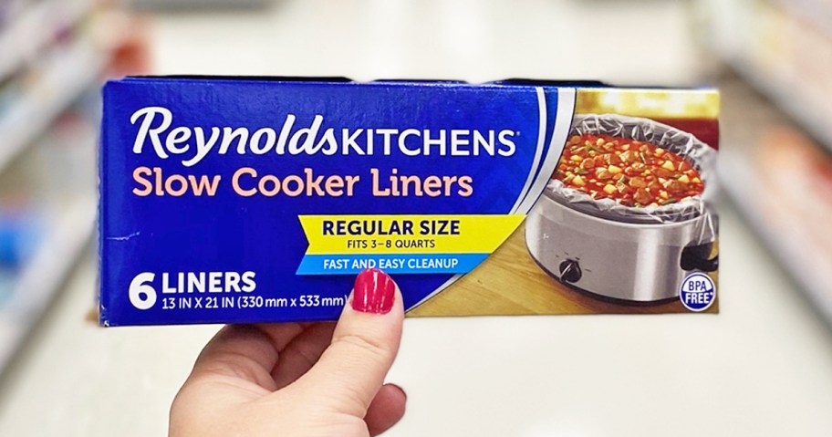 hand holding up a box of Reynolds Slow Cooker Liners in store