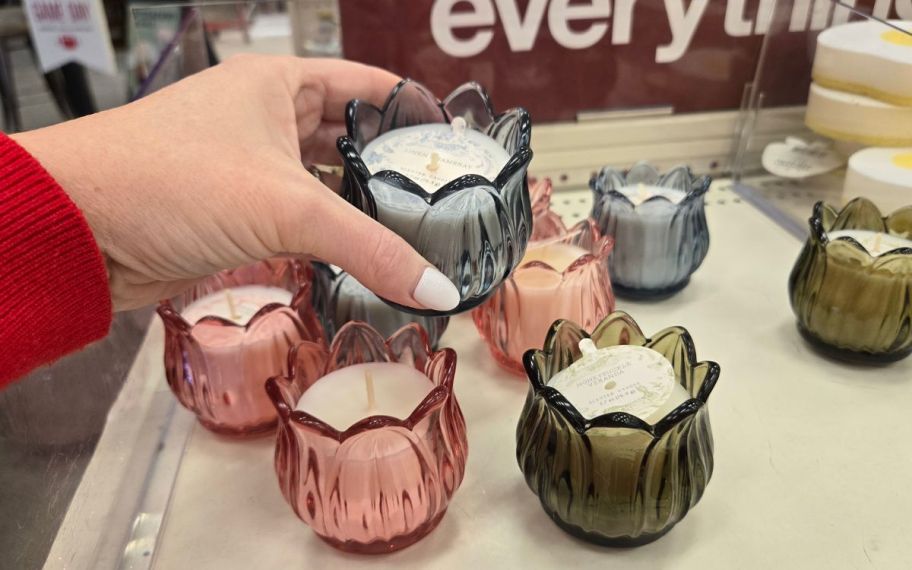 hand holding tulip candle in different colors