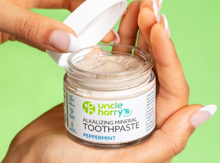 hand holding uncle harrys remineralizing toothpaste