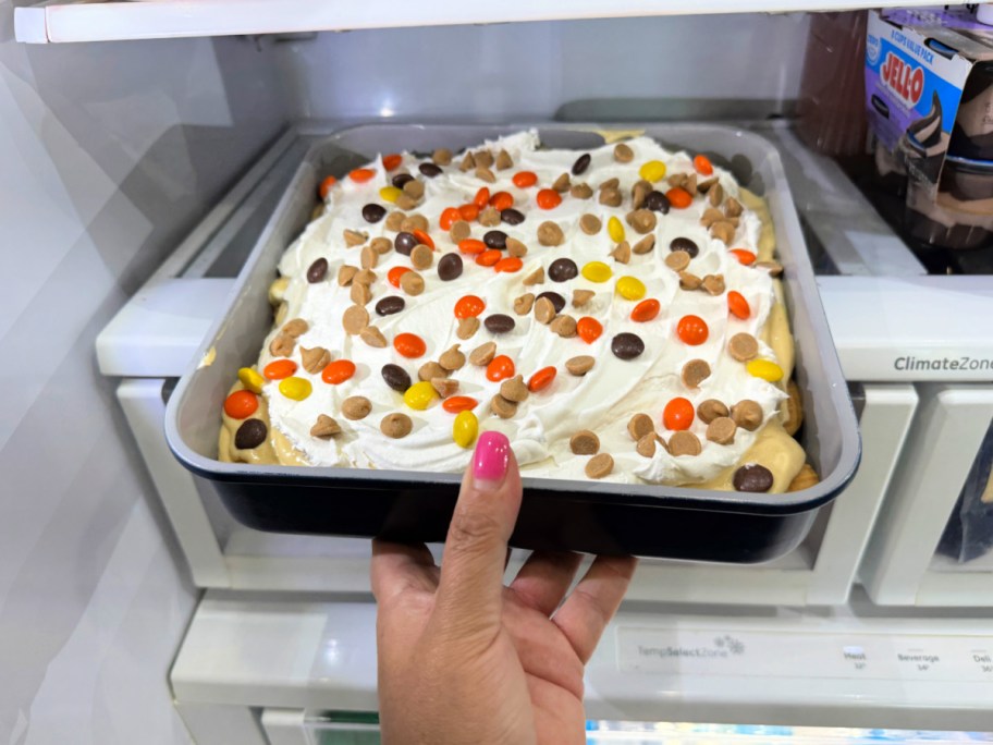 adding nutter butter cake to the fridge to chill