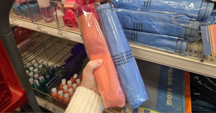two Collapsible Umbrellas in hand in store